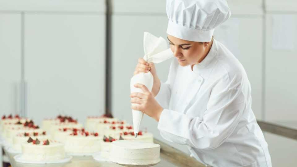 pastry chef decorating a cake